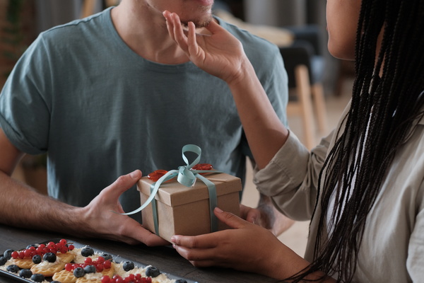 Couple Holds Present and Intend Kissing